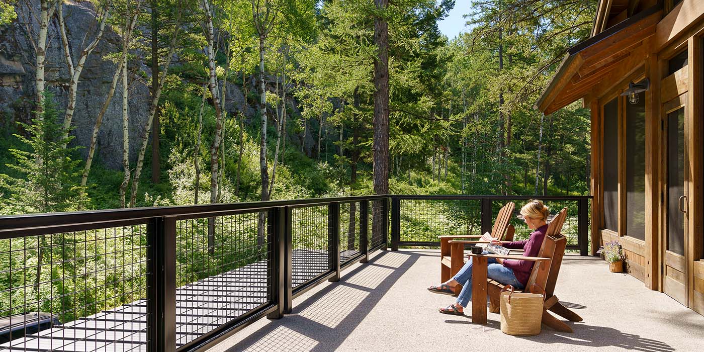 woman rests on a porch with mountain view